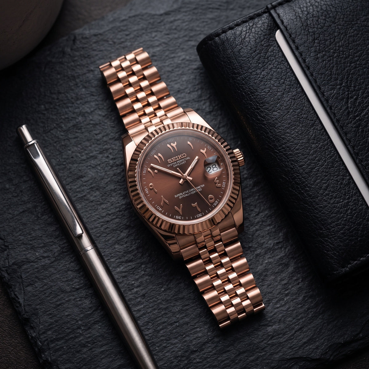 Date Mod – Rose Gold · Brown Arabic Dial – Automatic – lifestyle flat lay