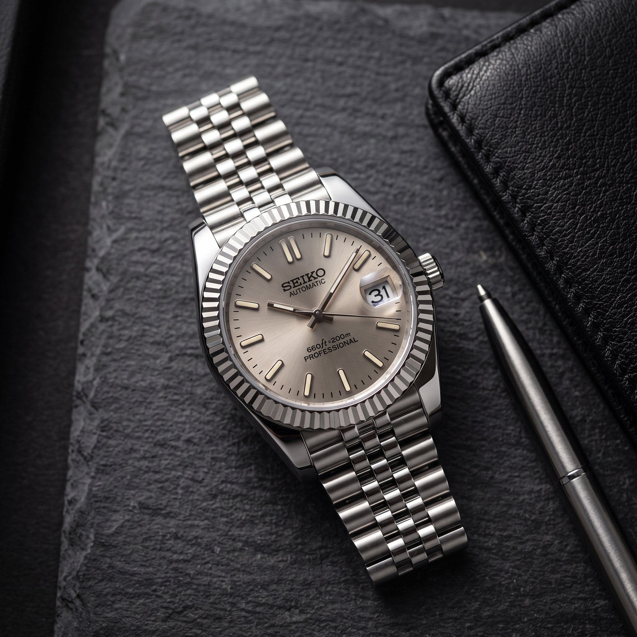 Date Mod – Steel · Taupe Stick Dial – Automatic – lifestyle flat lay