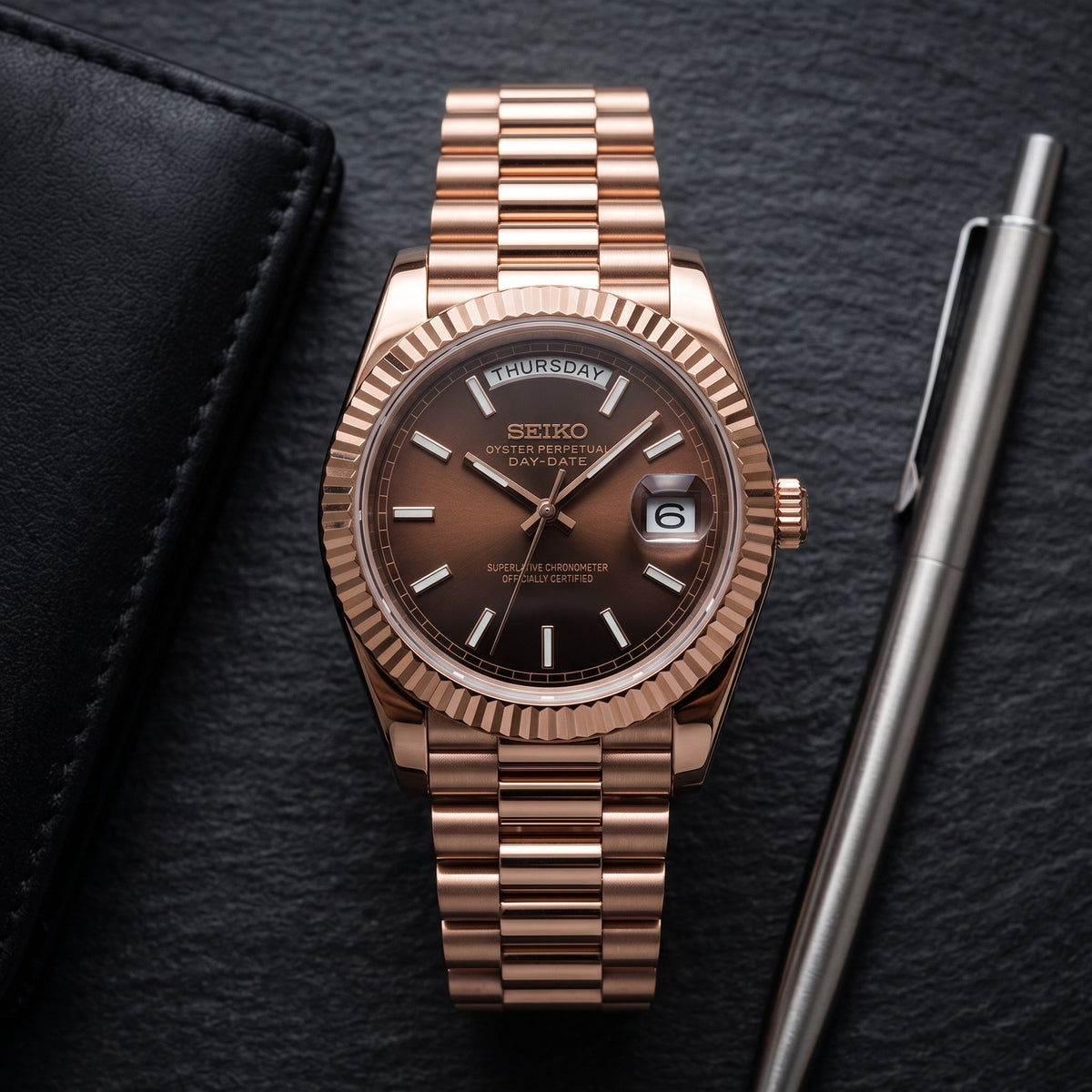 Day Mod – Rose Gold · Brown Dial – 40mm – Automatic – lifestyle flat lay