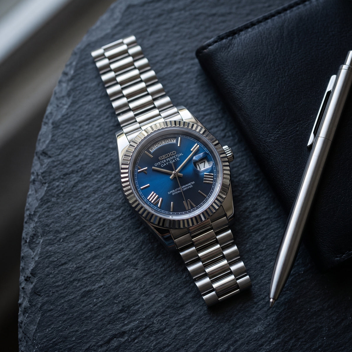 Day Mod – White Gold · Blue Roman Dial – 40mm – Automatic – lifestyle flat lay