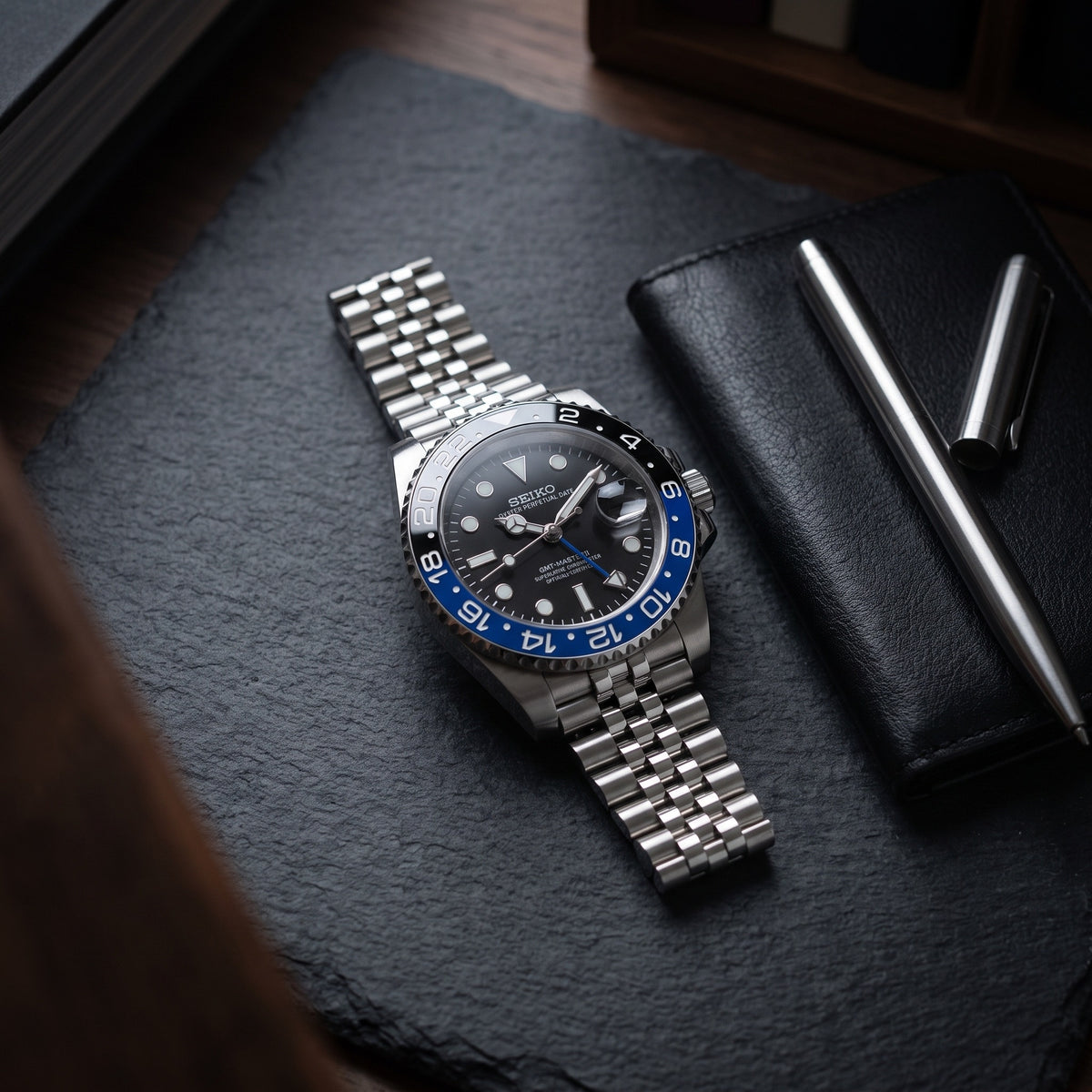 GMT Mod – Steel · Blue-Black Bezel · Jubilee – 40mm – Automatic GMT – lifestyle flat lay