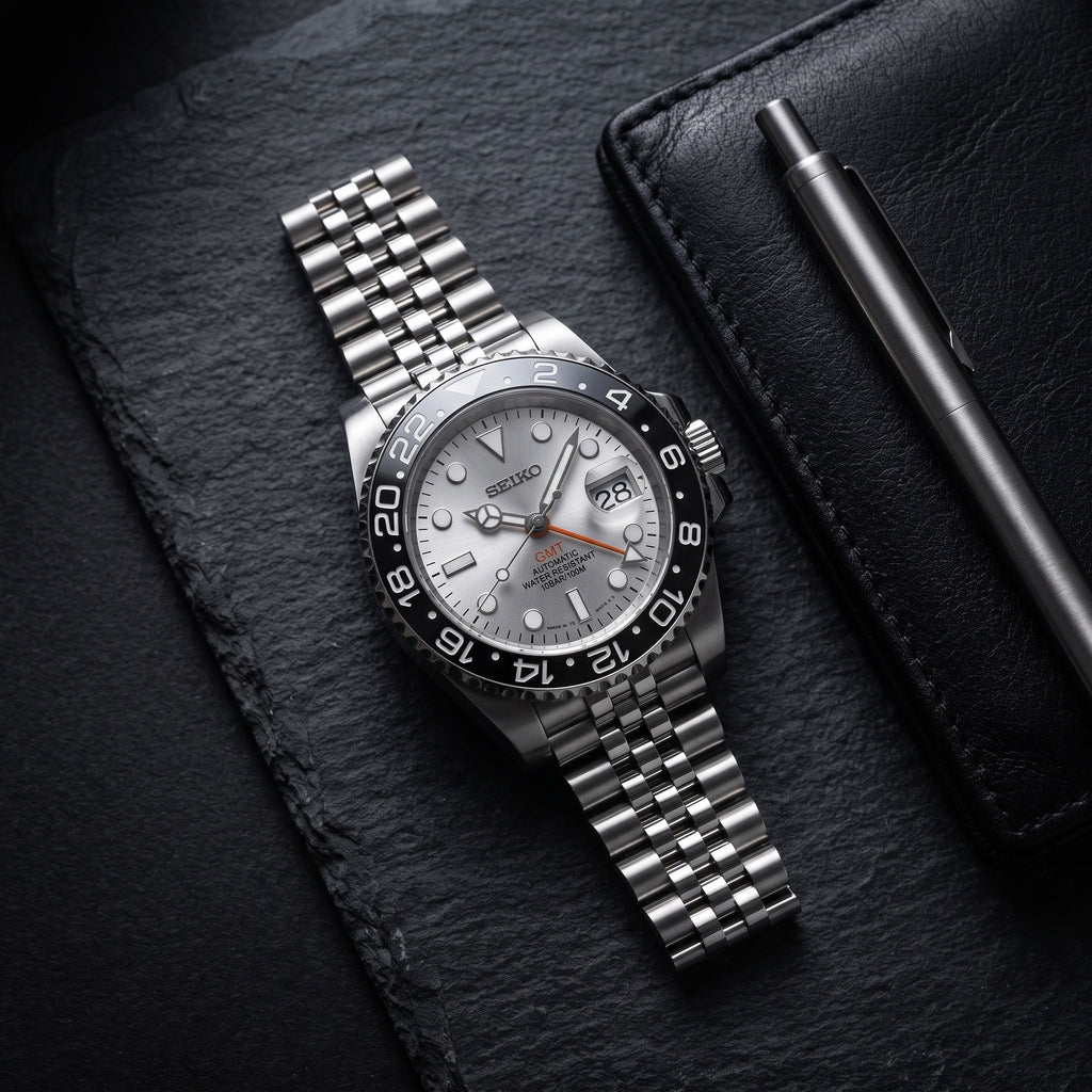 GMT Mod – Steel · Grey Bezel · Silver Dial – 40mm – Automatic GMT – lifestyle flat lay