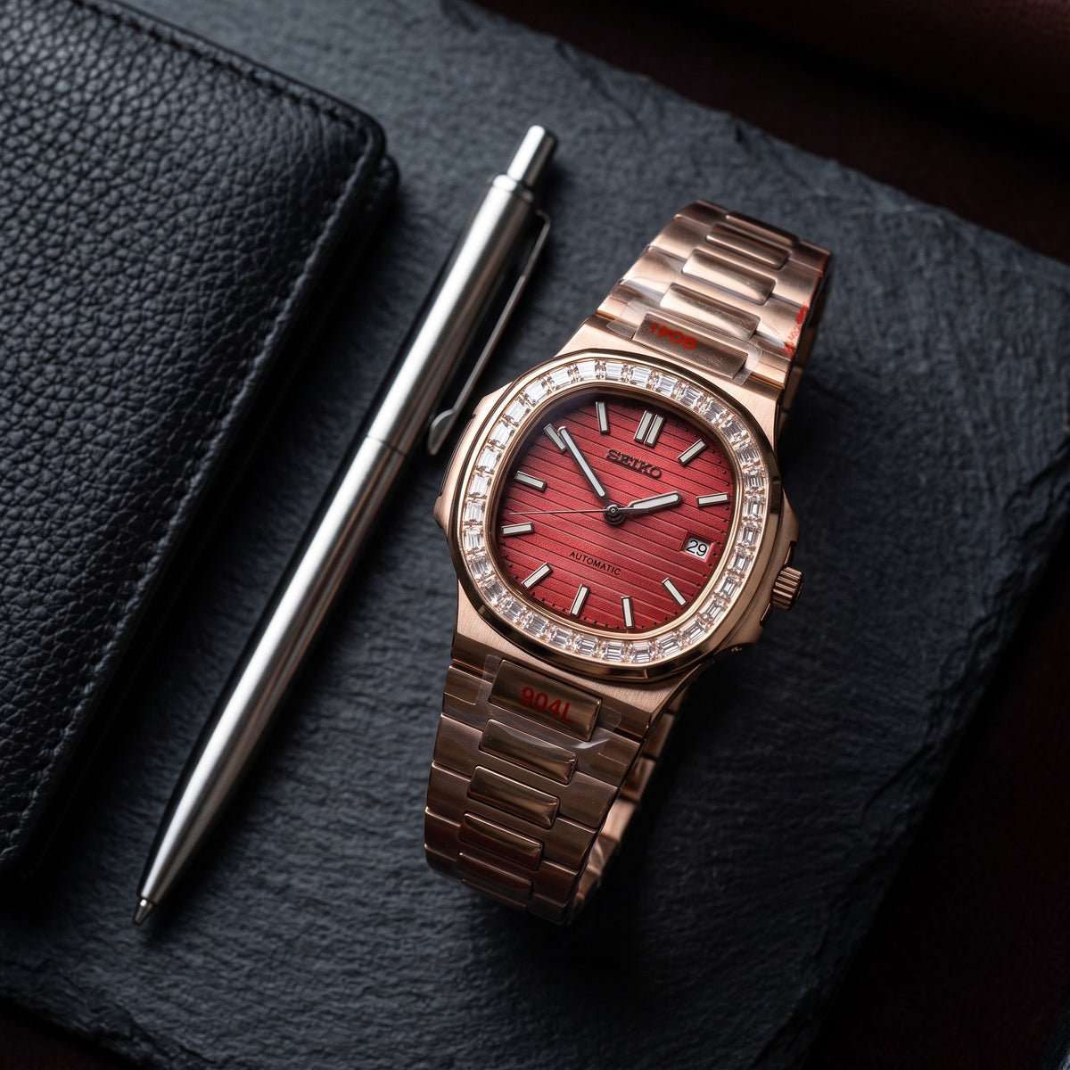 Naut Mod – Rose Gold · Diamond Bezel · Red Dial – 41mm – Automatic – lifestyle flat lay