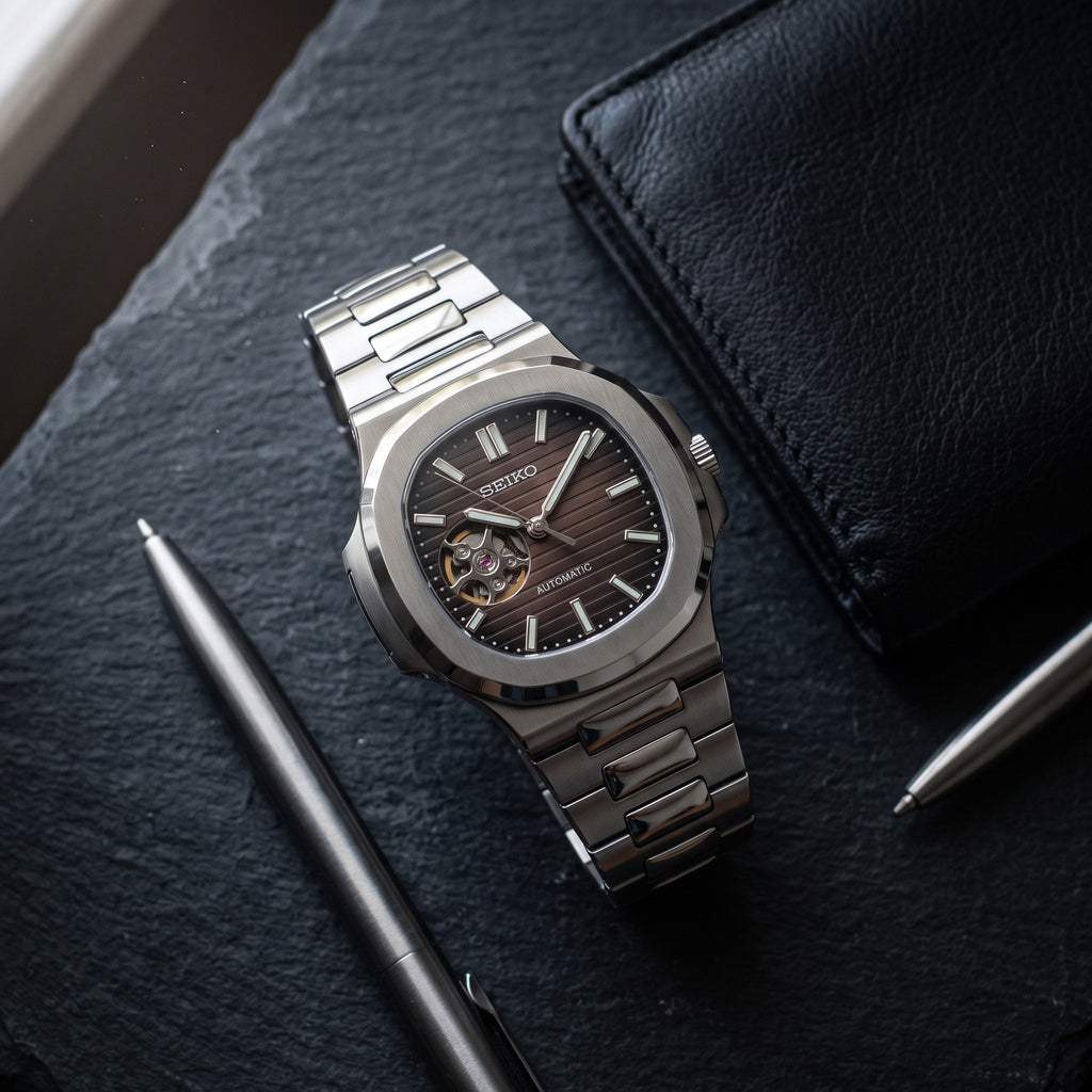 Naut Mod – Steel · Brown Open-Heart Dial – 41mm – Automatic – lifestyle flat lay