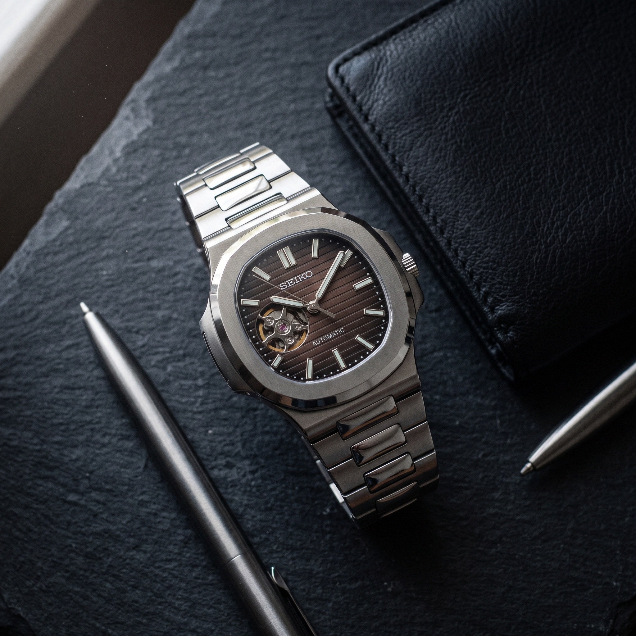 Naut Mod – Steel · Brown Open-Heart Dial – 41mm – Automatic – lifestyle flat lay