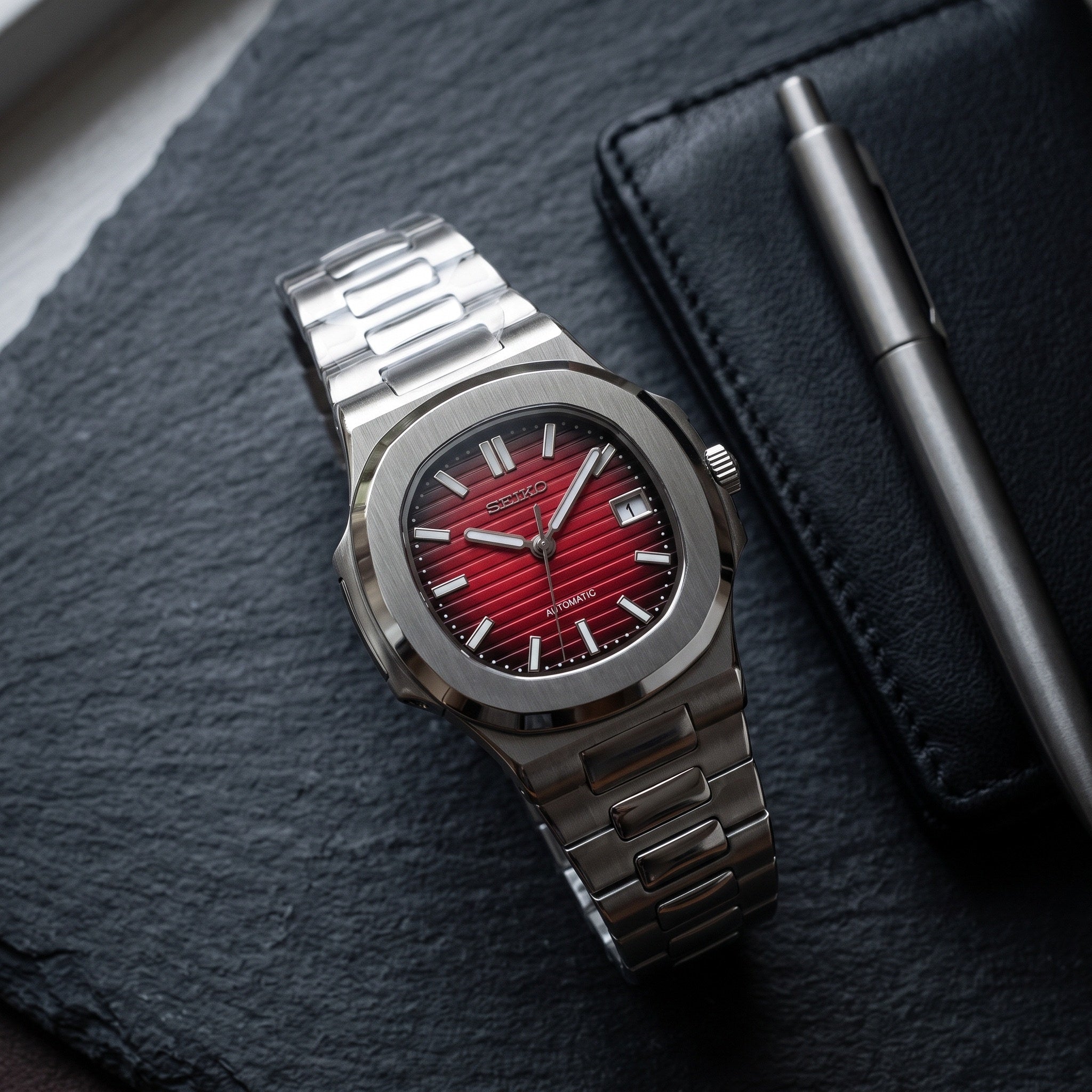 Naut Mod – Steel · Red Dial – 41mm – Automatic – lifestyle flat lay