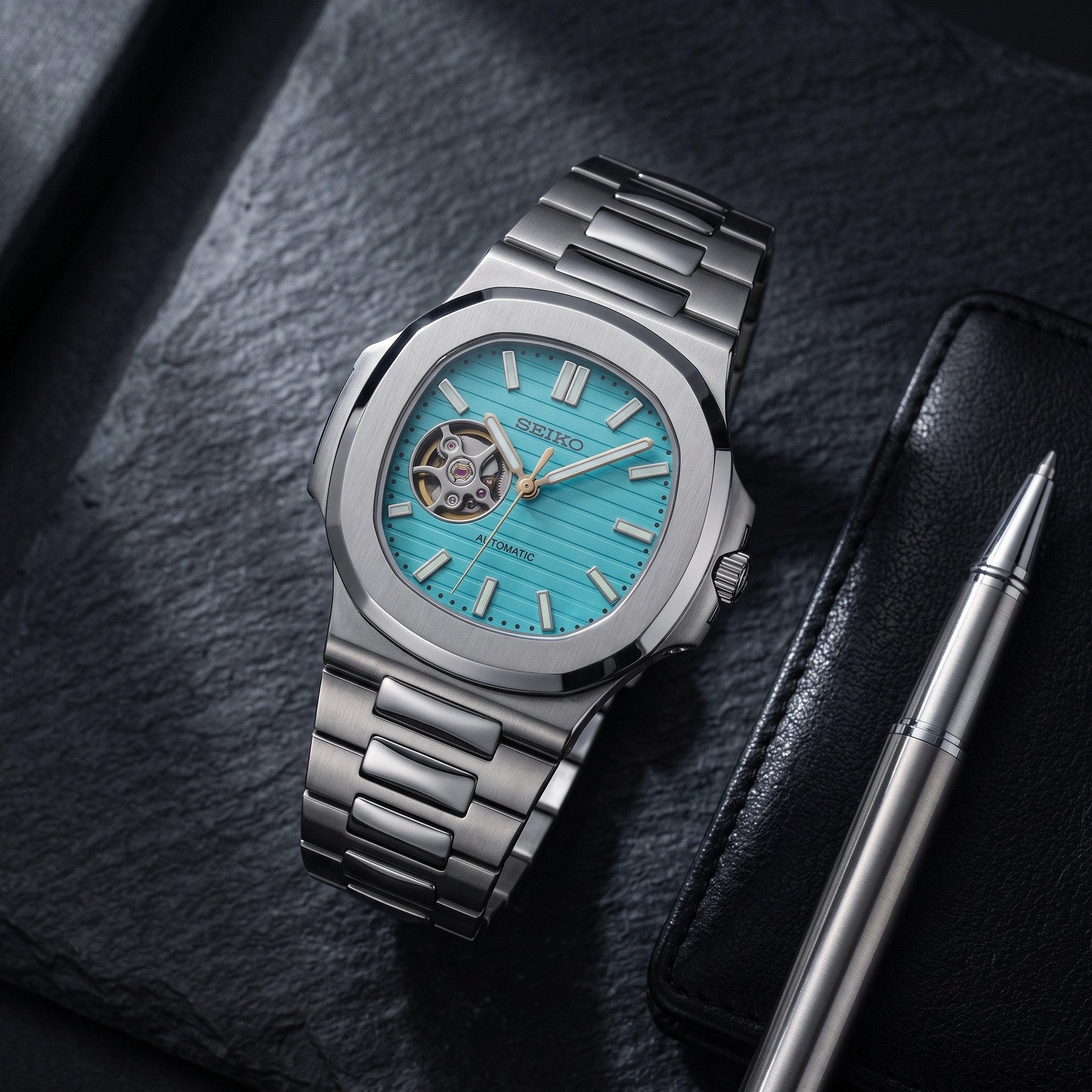 Naut Mod – Steel · Teal Open-Heart Dial – 41mm – Automatic – lifestyle flat lay