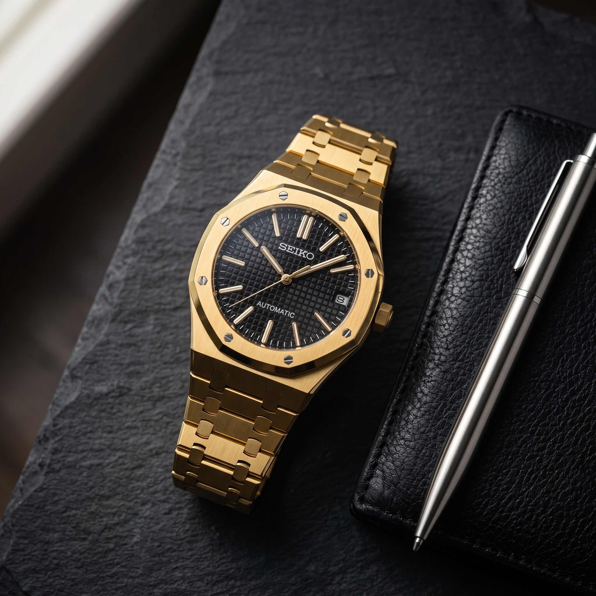 Oak Mod – Gold · Black Tapisserie Dial – 41mm – Automatic – lifestyle flat lay