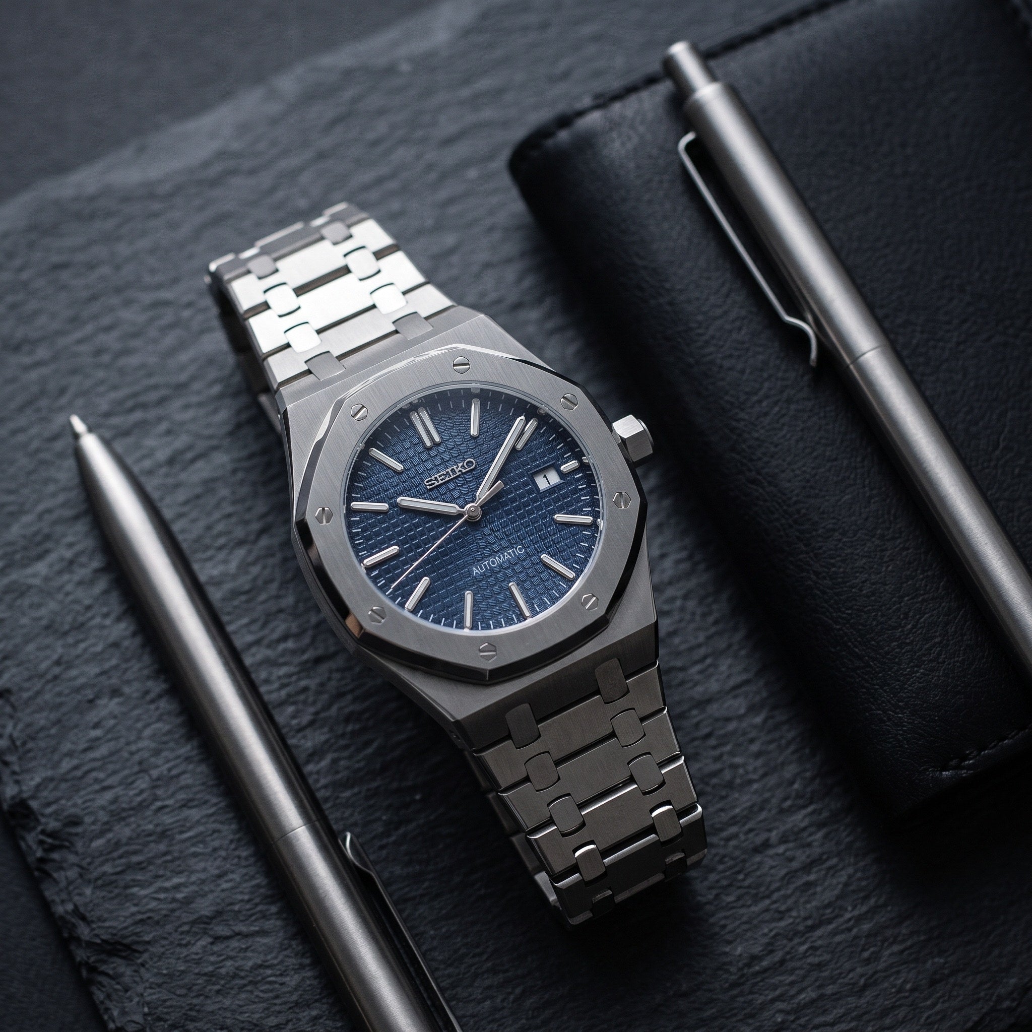 Oak Mod – Steel · Blue Tapisserie Dial – 41mm – Automatic – lifestyle flat lay