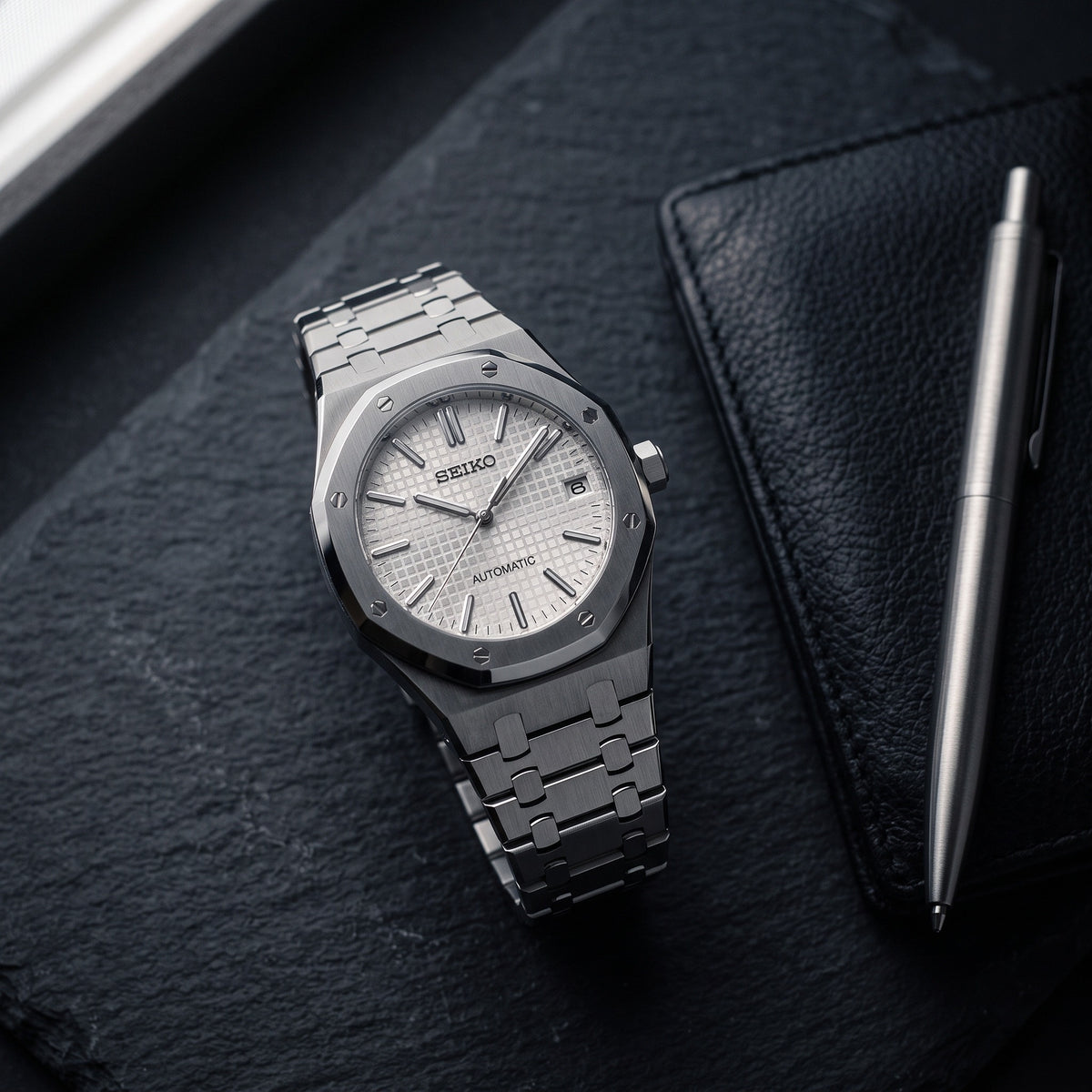 Oak Mod – Steel · White Tapisserie Dial – 41mm – Automatic – lifestyle flat lay